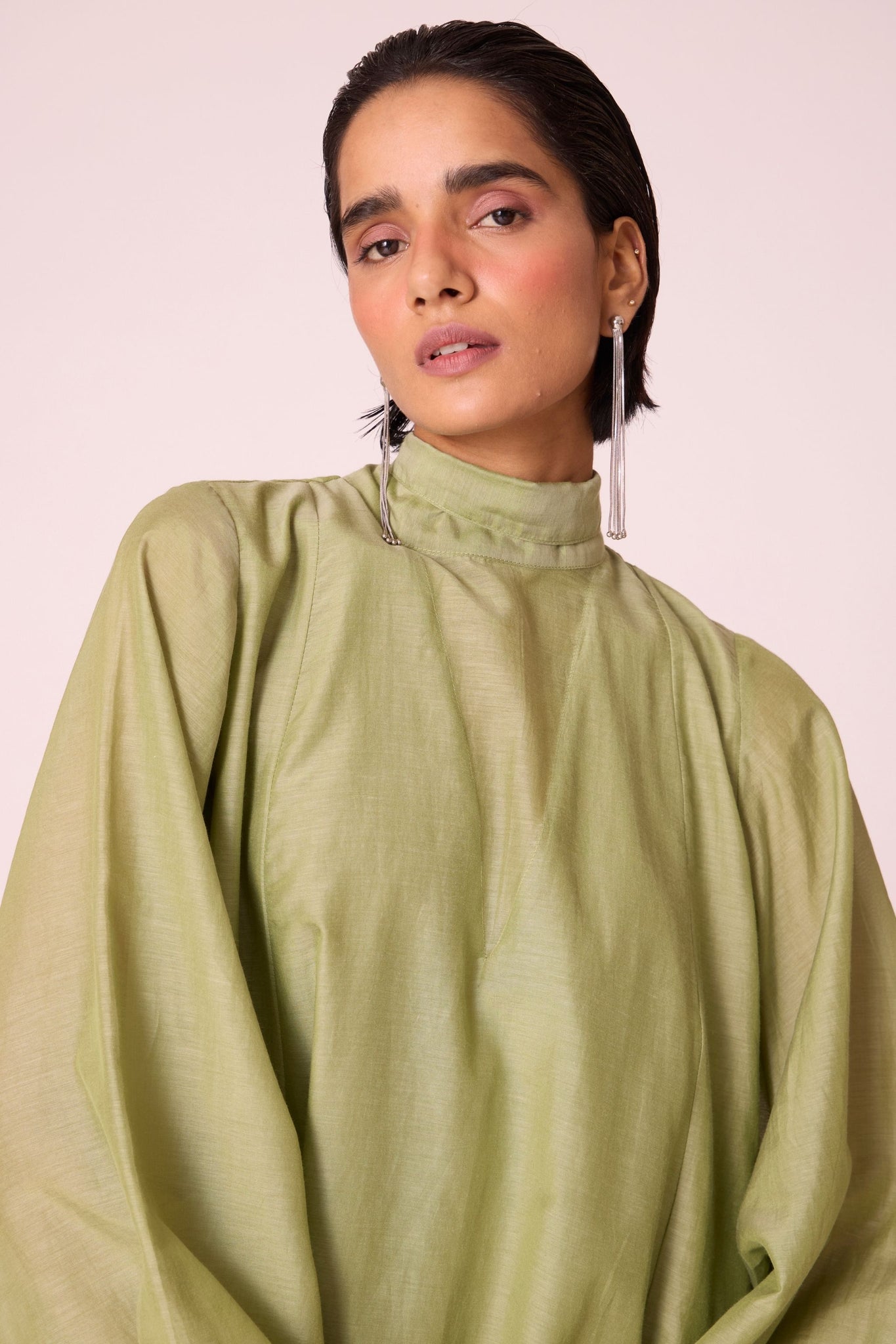 Green silk-cotton panelled short dress with halter neck, back tie, bishop sleeves, and lined body.