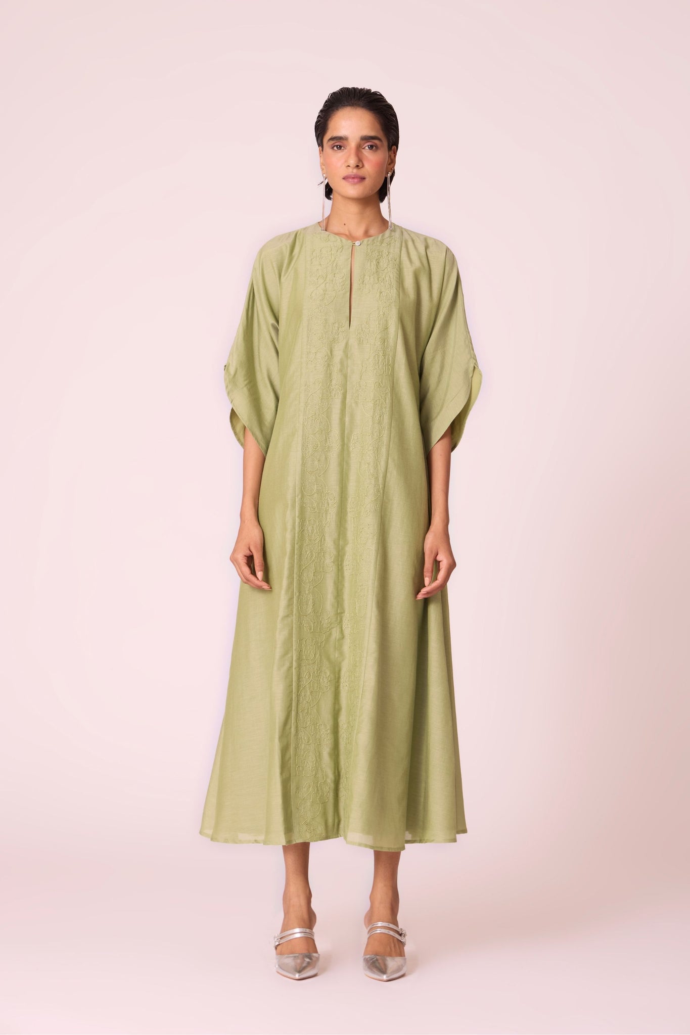 Green silk-cotton dress with hand-embroidered keyhole neckline, drop sleeves, full lining, and in-seam pockets.