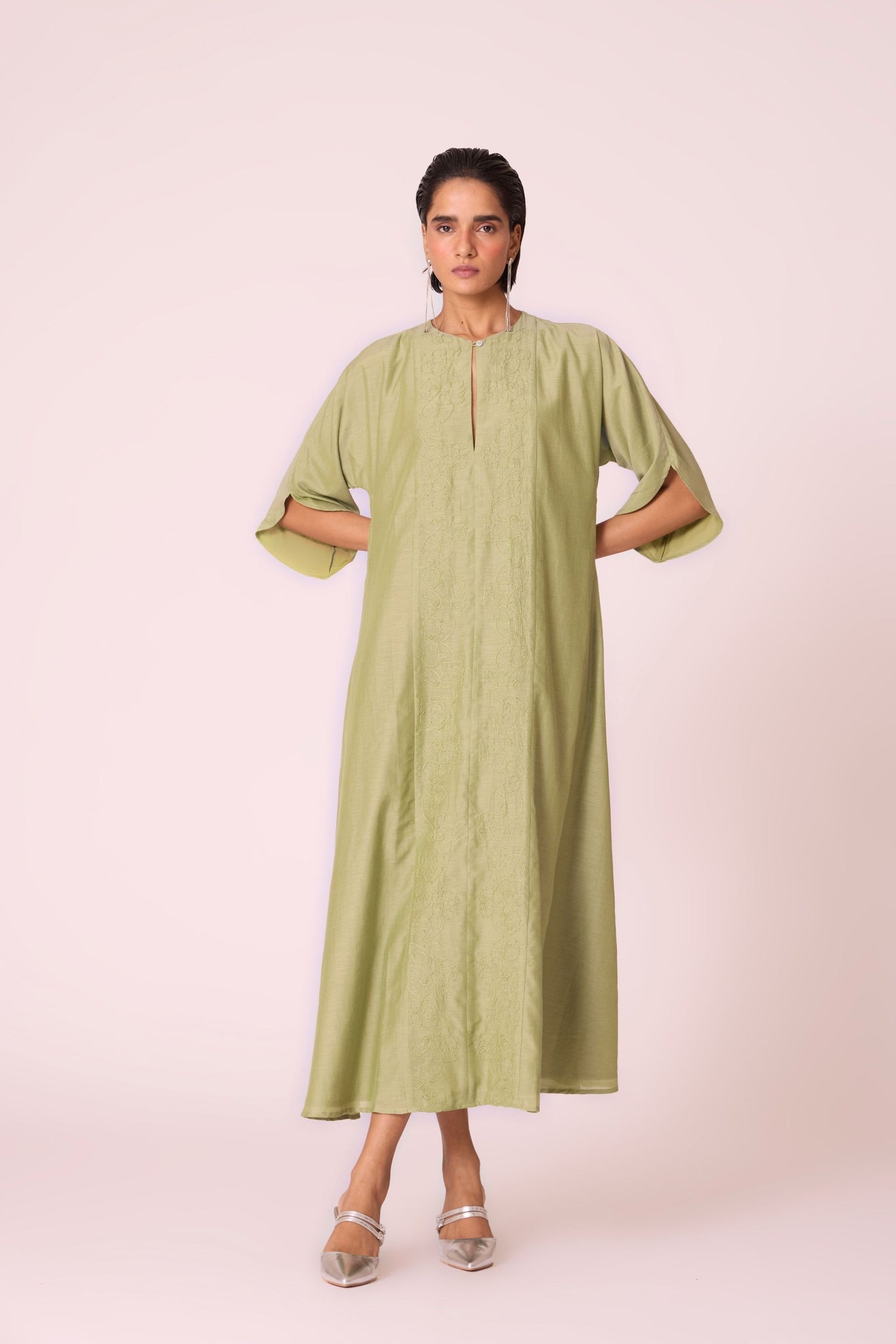 Green silk-cotton dress with hand-embroidered keyhole neckline, drop sleeves, full lining, and in-seam pockets.