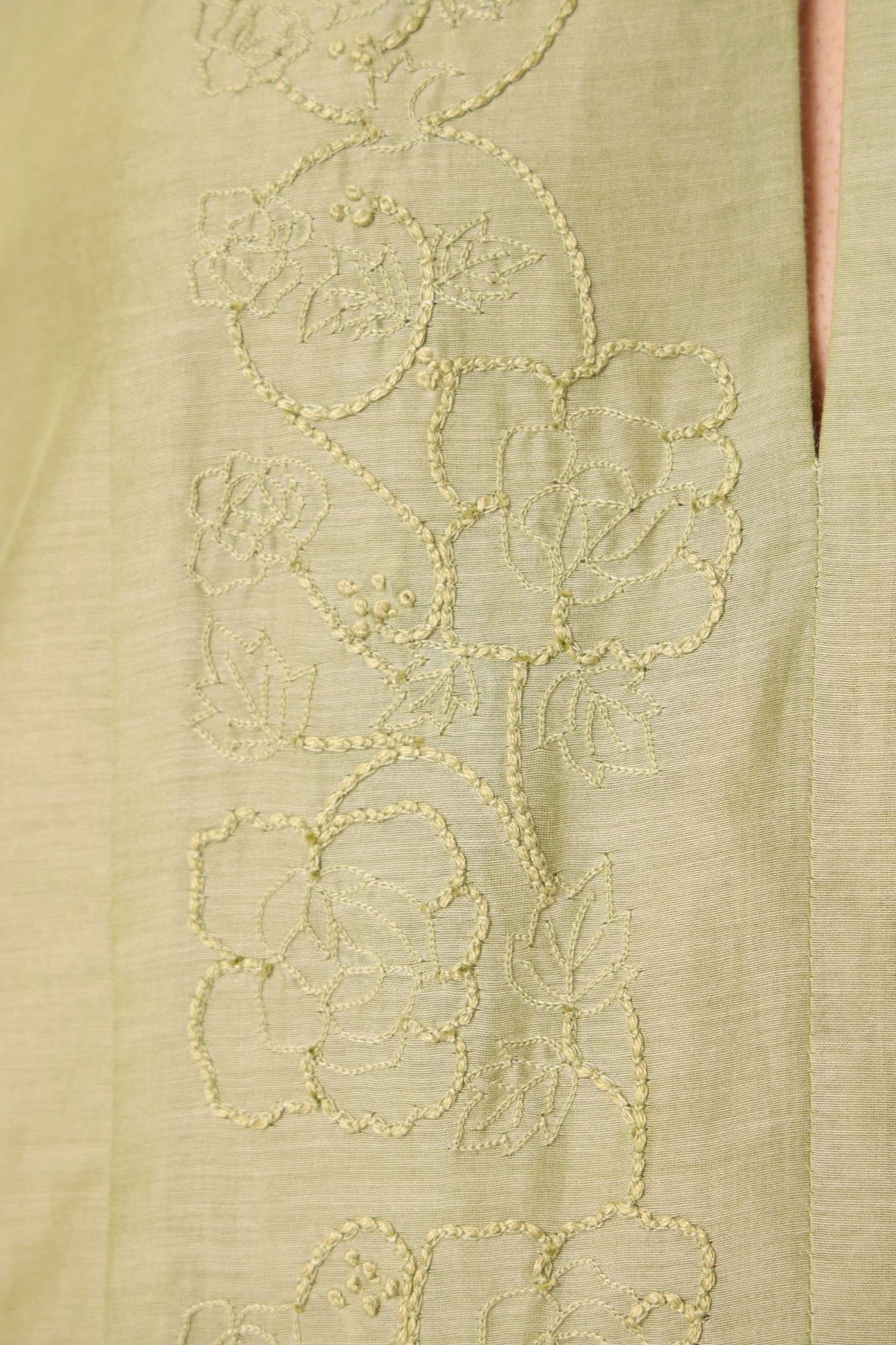 Green silk-cotton dress with hand-embroidered keyhole neckline, drop sleeves, full lining, and in-seam pockets.