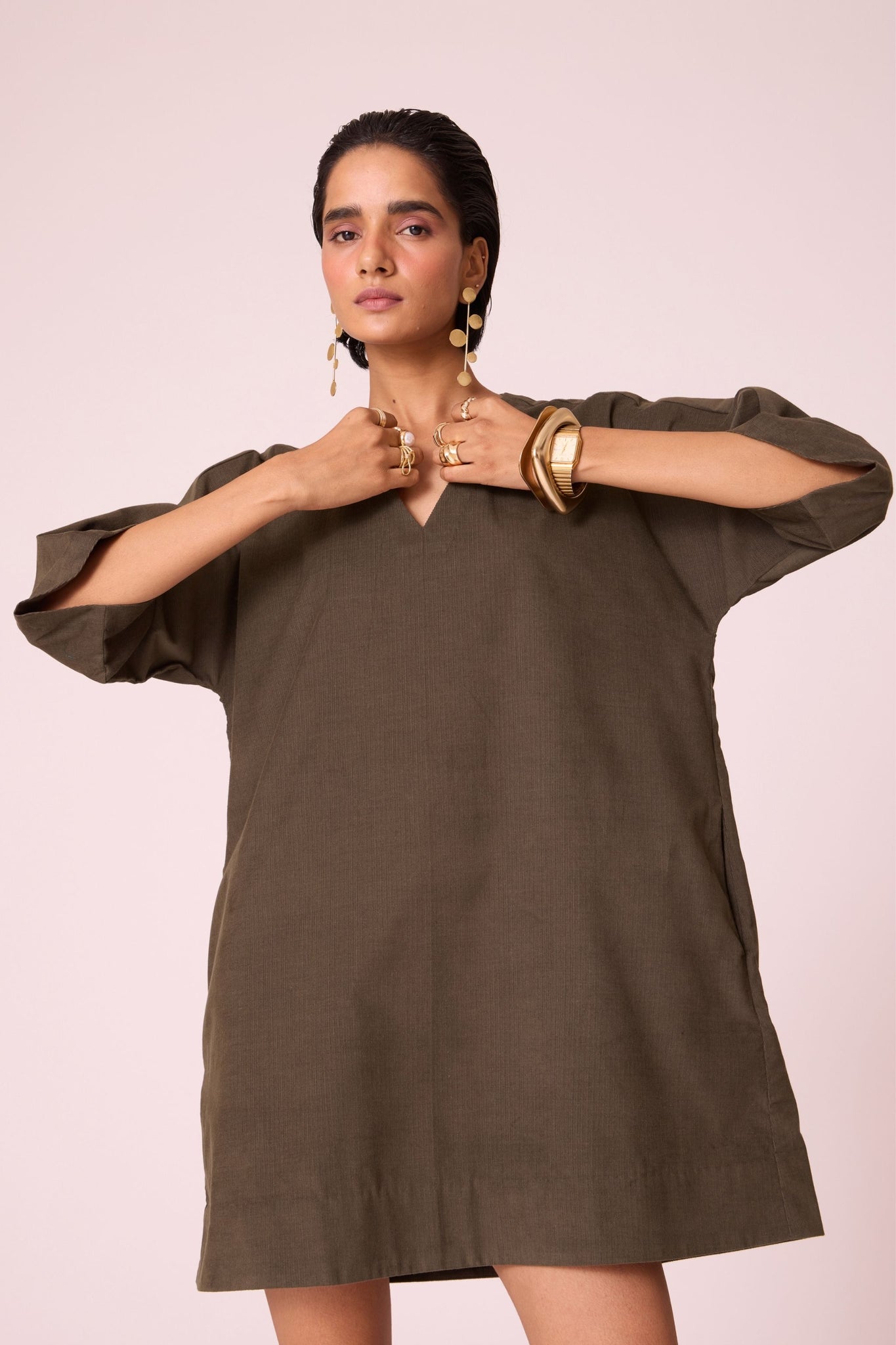 Olive needlecord shift dress with V-neckline, kimono-inspired sleeves, and in-seam pockets.
