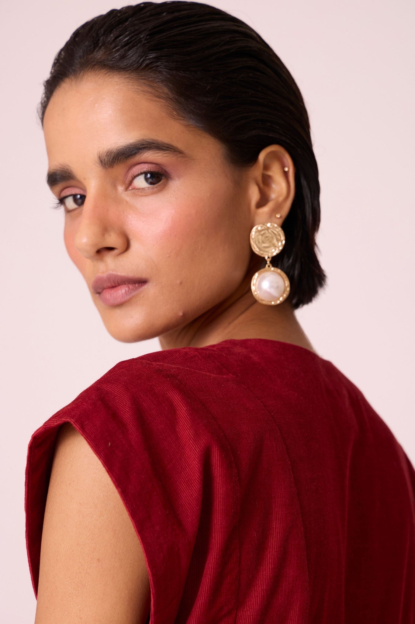 Rust needlecord panelled dress with box pleats, structured drop shoulder, V-neckline, side zip, and in-seam pockets.