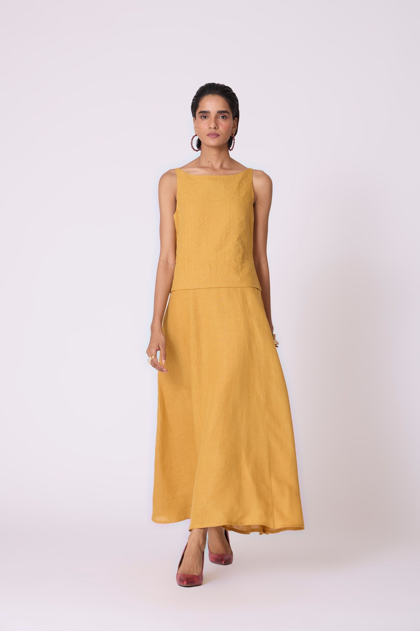 Yellow linen panelled dress with quilted low-waist yoke, paneled hemline, full lining, and in-seam pockets.