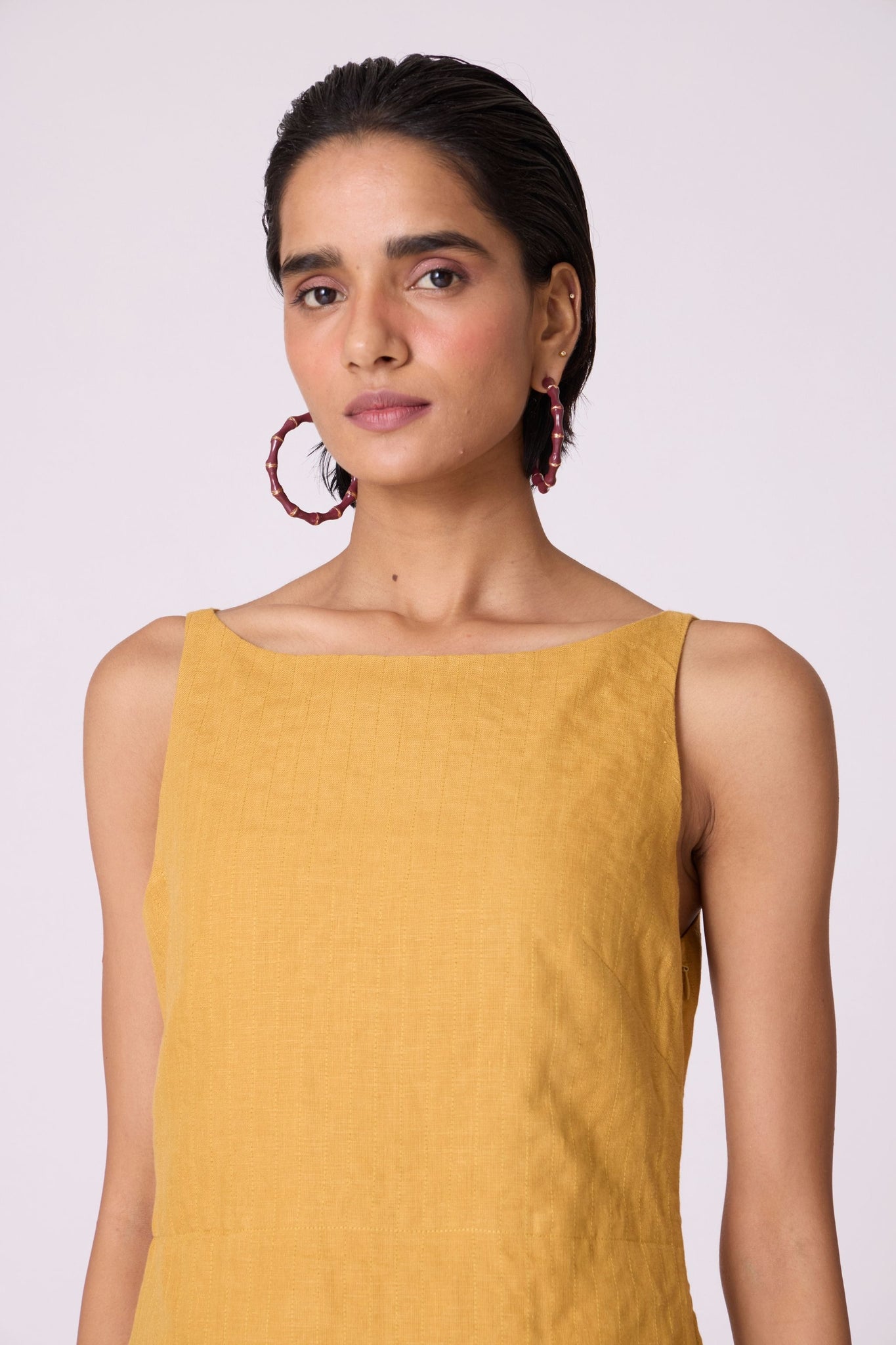 Yellow linen panelled dress with quilted low-waist yoke, paneled hemline, full lining, and in-seam pockets.