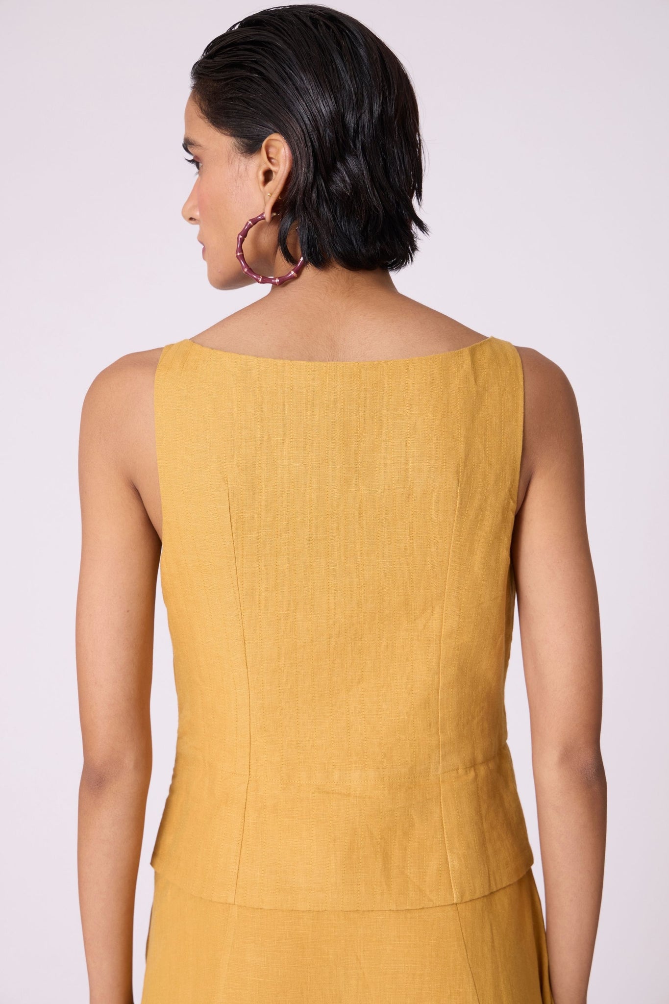 Yellow linen panelled dress with quilted low-waist yoke, paneled hemline, full lining, and in-seam pockets.