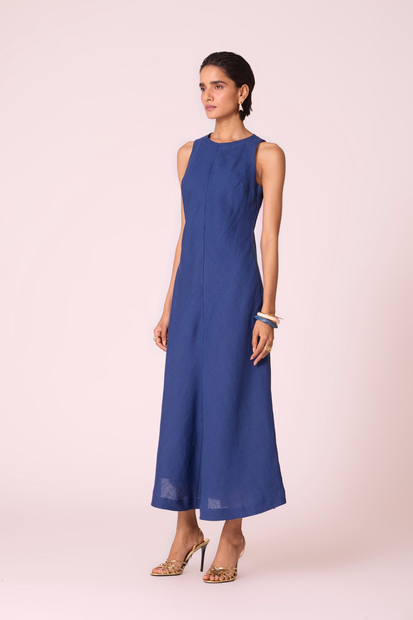 Ink blue linen midi dress with high neckline, cutaway sleeves, back zip, full lining, and in-seam pockets.