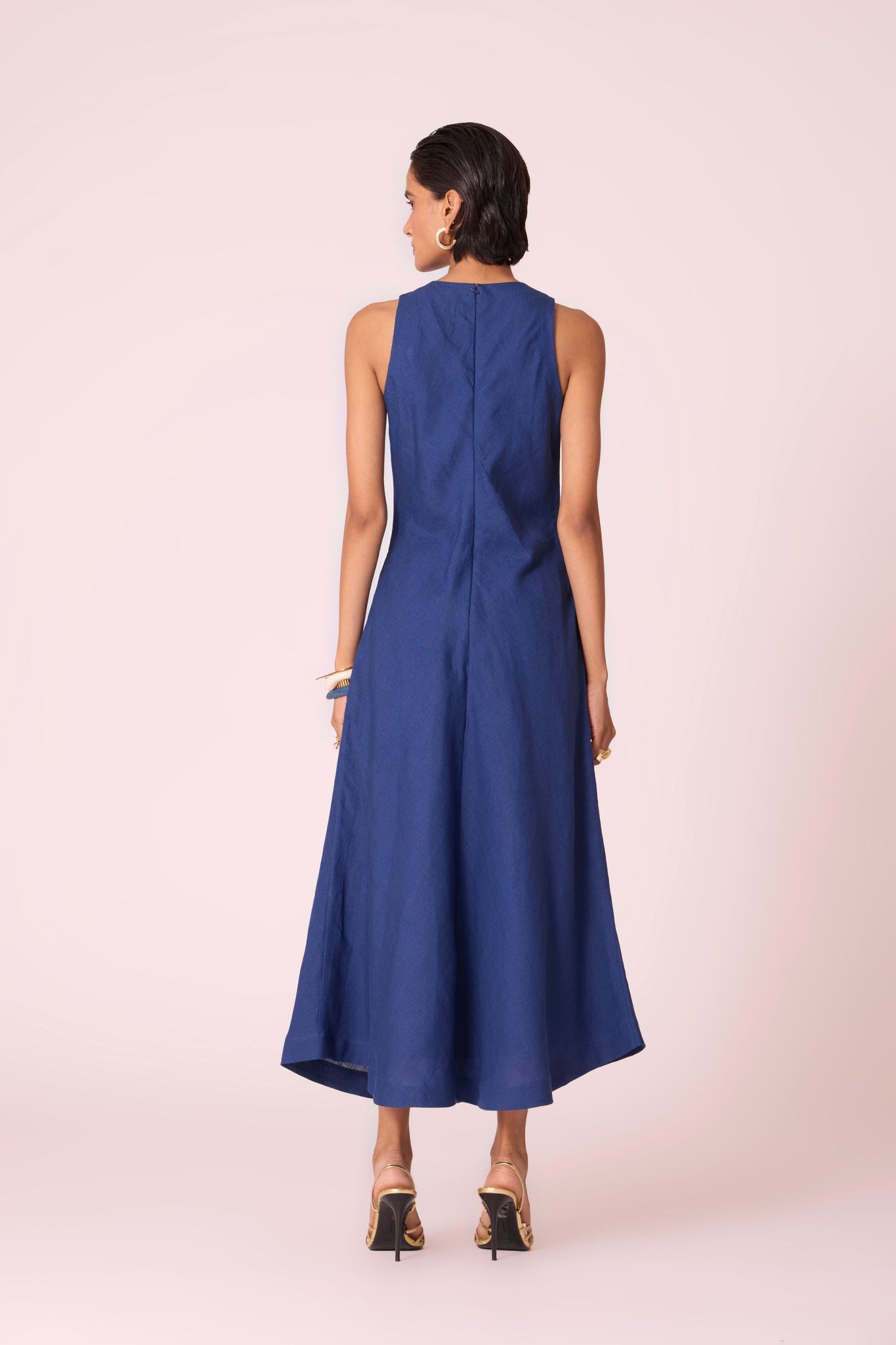 Ink blue linen midi dress with high neckline, cutaway sleeves, back zip, full lining, and in-seam pockets.
