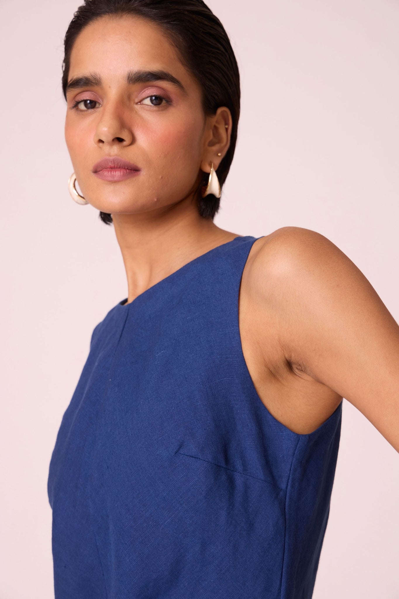 Ink blue linen midi dress with high neckline, cutaway sleeves, back zip, full lining, and in-seam pockets.