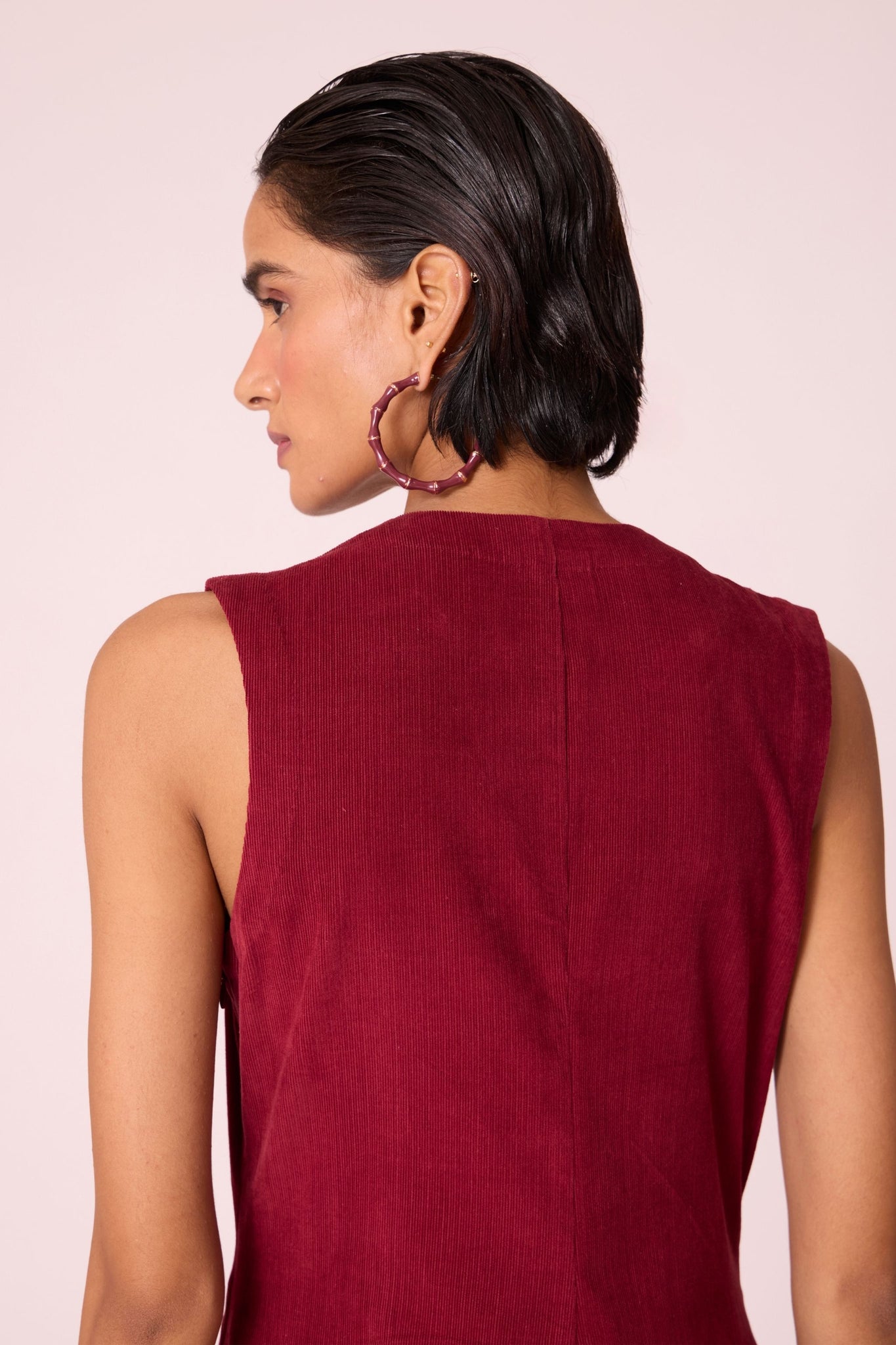 Cherry needlecord fit-and-flare midi dress with soft V-neckline, panel detailing, side zip, and in-seam pockets.
