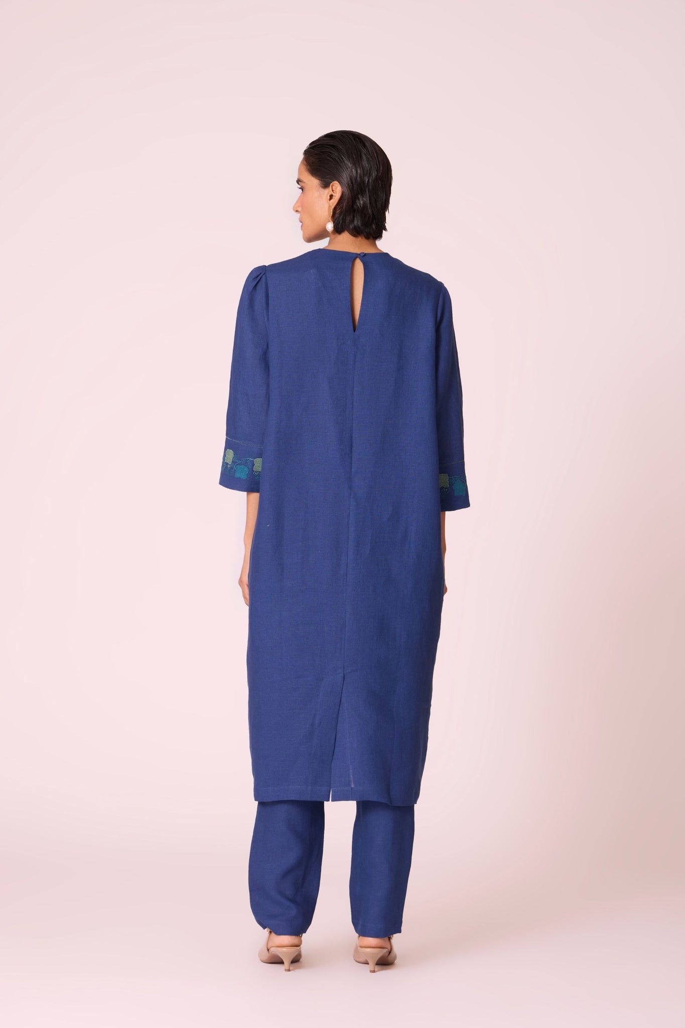 Ink blue linen tunic set with hand-embroidered 3/4 sleeves, back button tunic, and slim-fit side-zip pants.