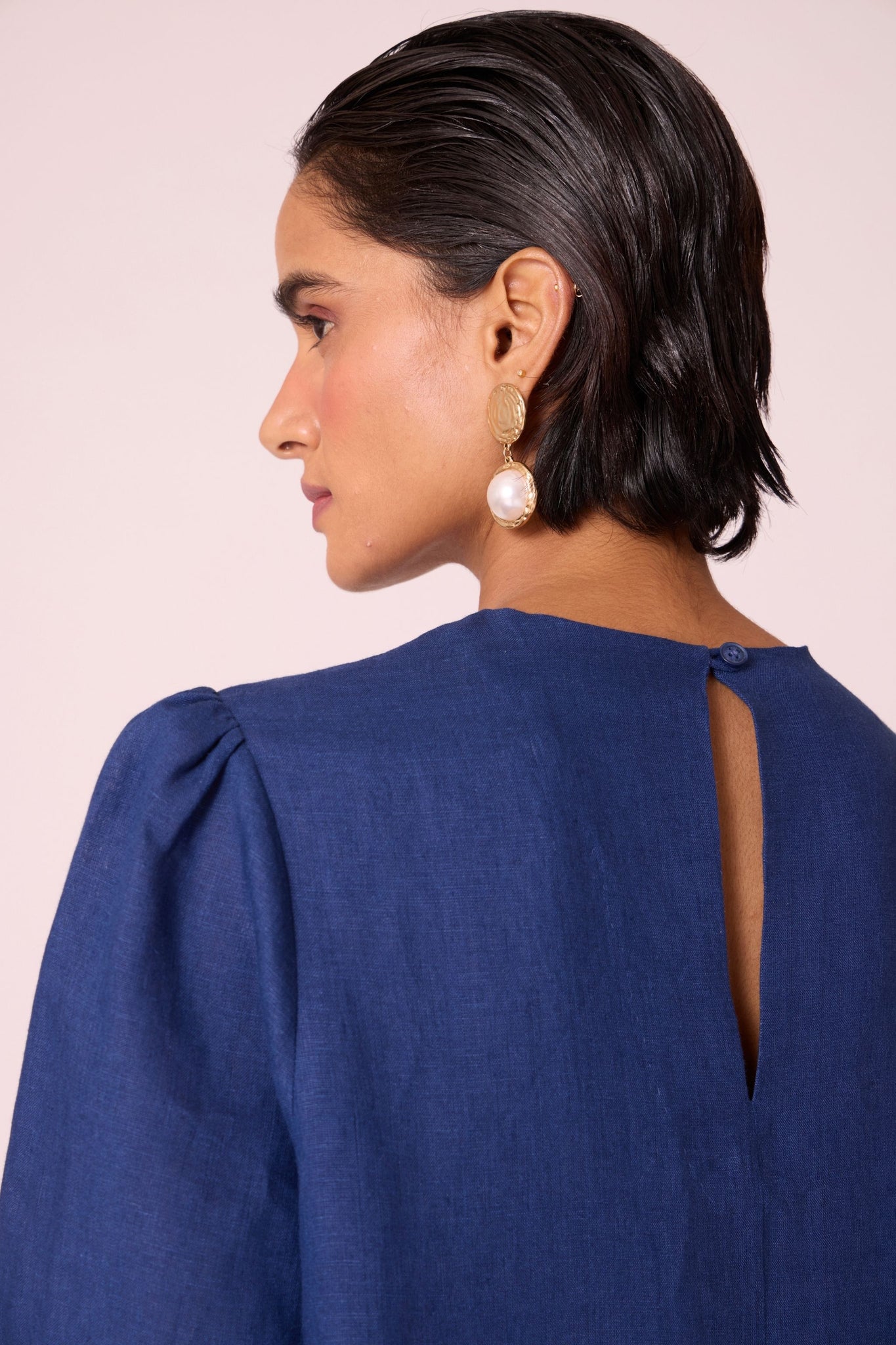 Ink blue linen tunic set with hand-embroidered 3/4 sleeves, back button tunic, and slim-fit side-zip pants.