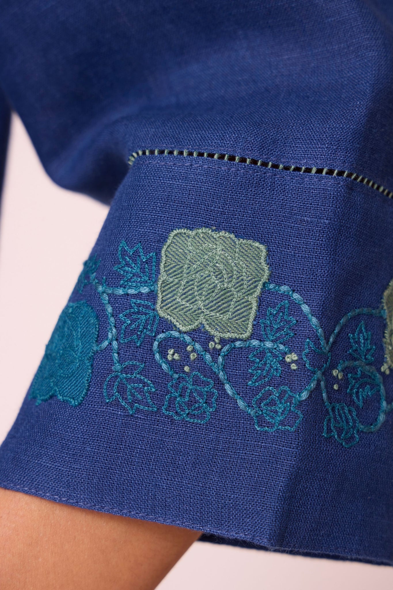 Ink blue linen tunic set with hand-embroidered 3/4 sleeves, back button tunic, and slim-fit side-zip pants.