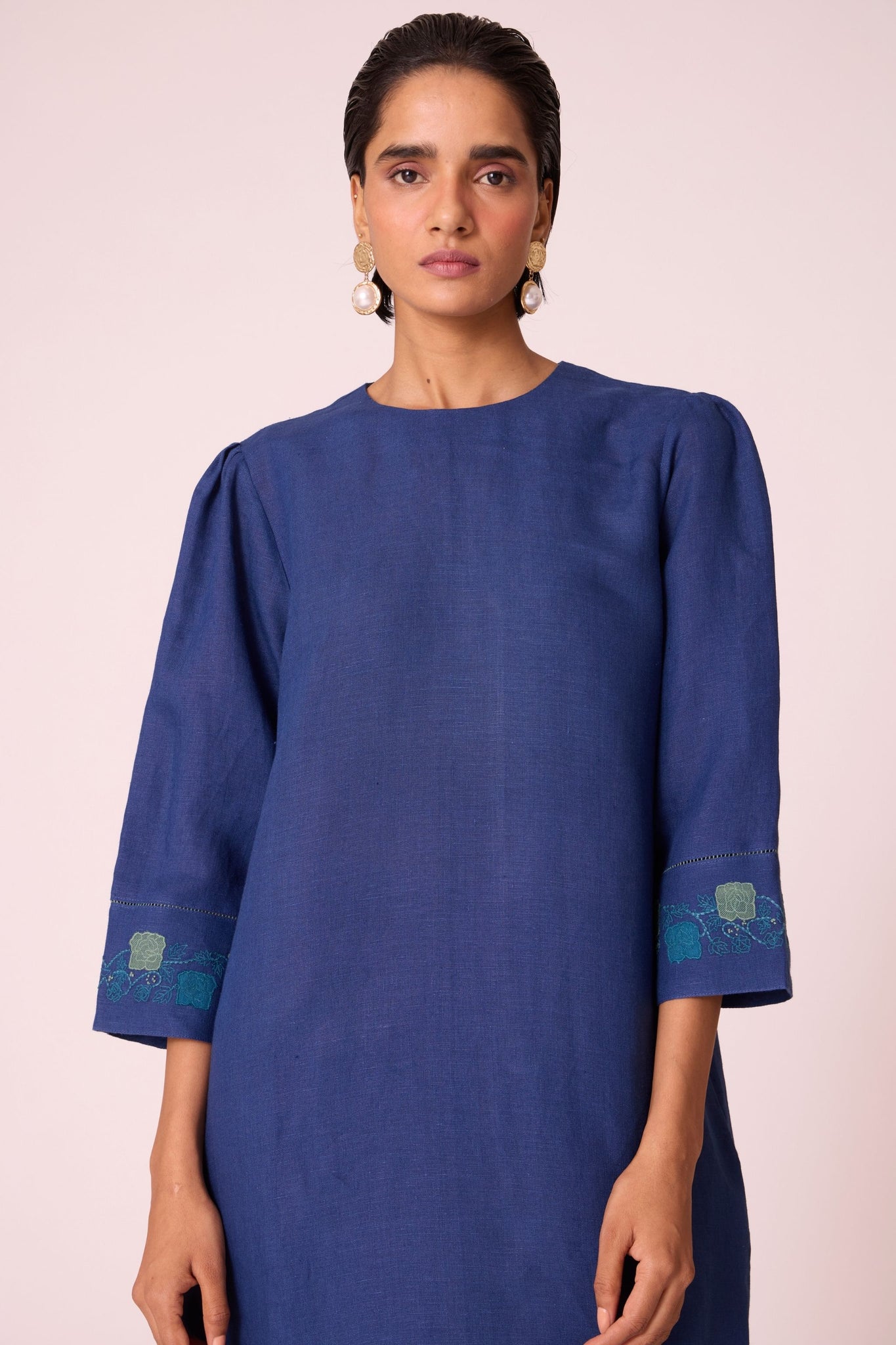 Ink blue linen tunic set with hand-embroidered 3/4 sleeves, back button tunic, and slim-fit side-zip pants.