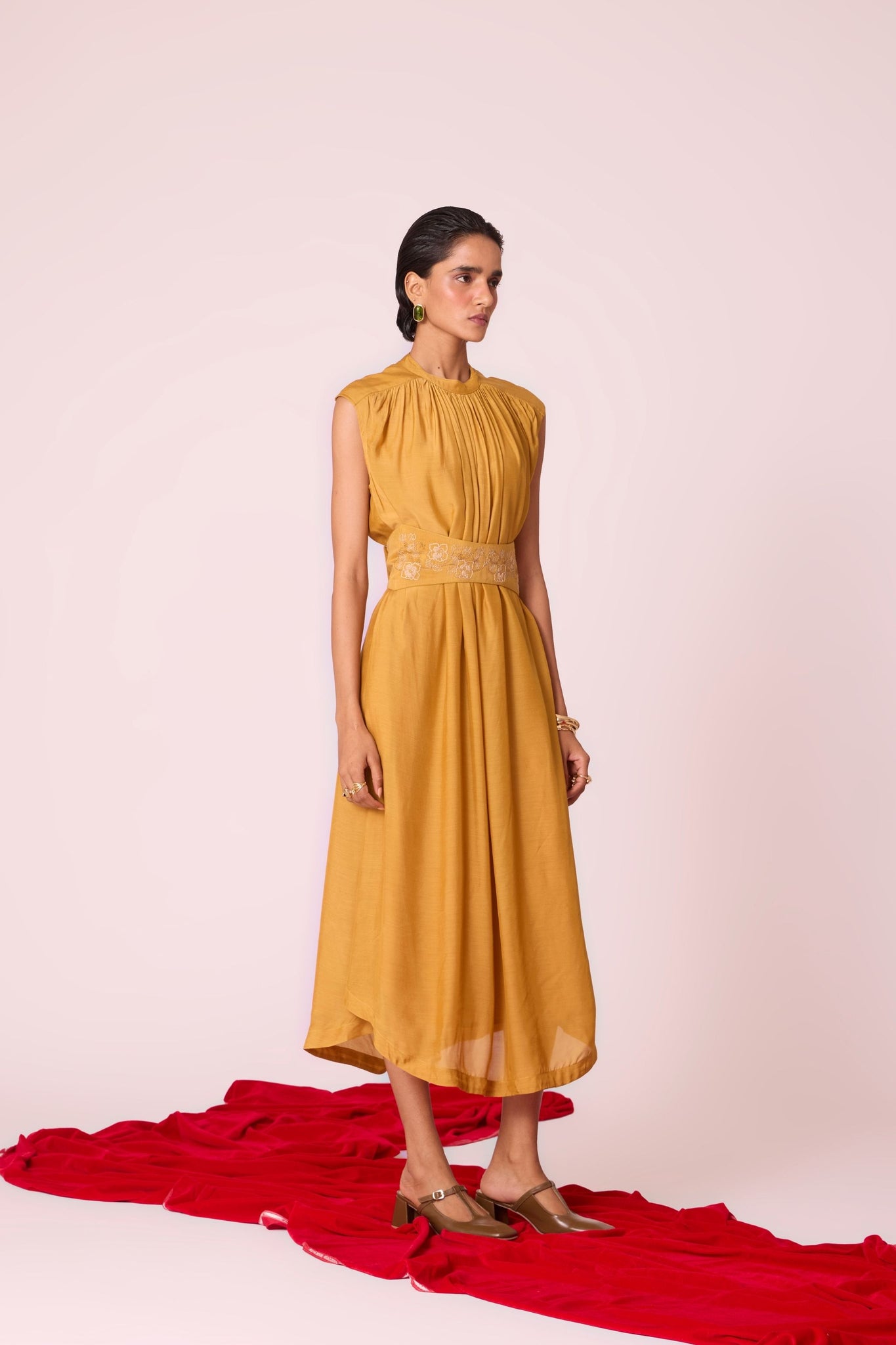 Yellow cupro midi dress with adjustable hand-embroidered belt, back button fastening, and slip included.
