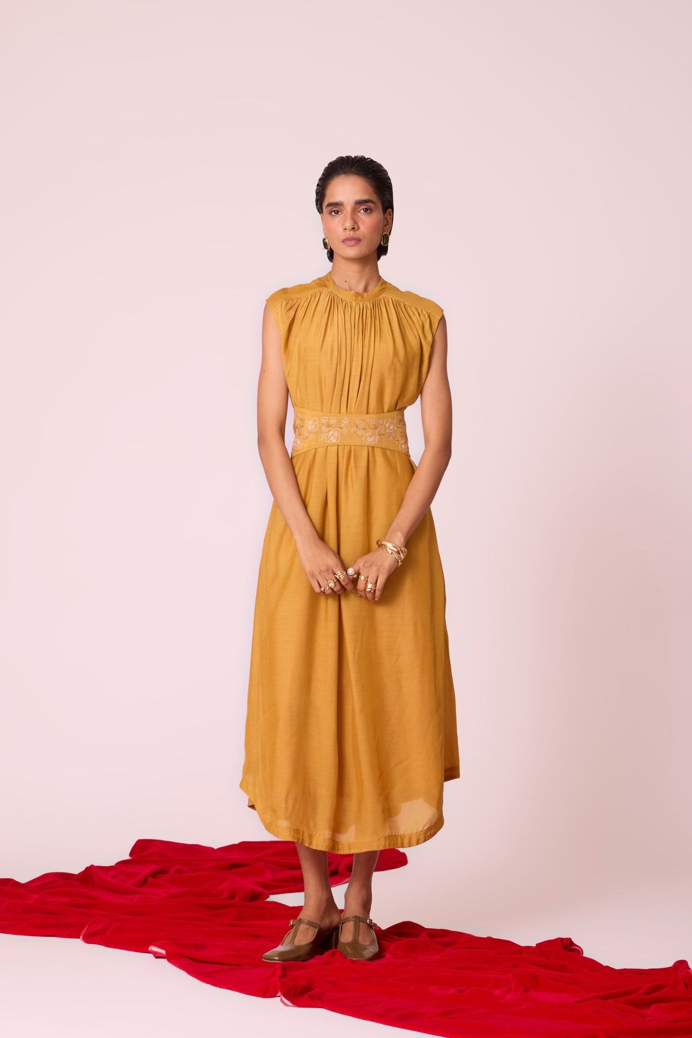 Yellow cupro midi dress with adjustable hand-embroidered belt, back button fastening, and slip included.

