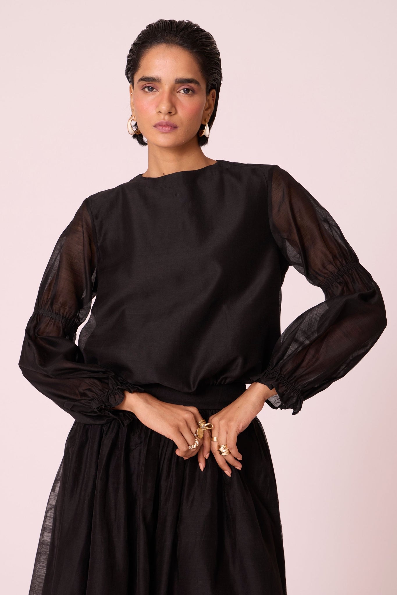 Black handwoven Chanderi top with drawstring waist, back button fastening, and elasticated sleeve details.