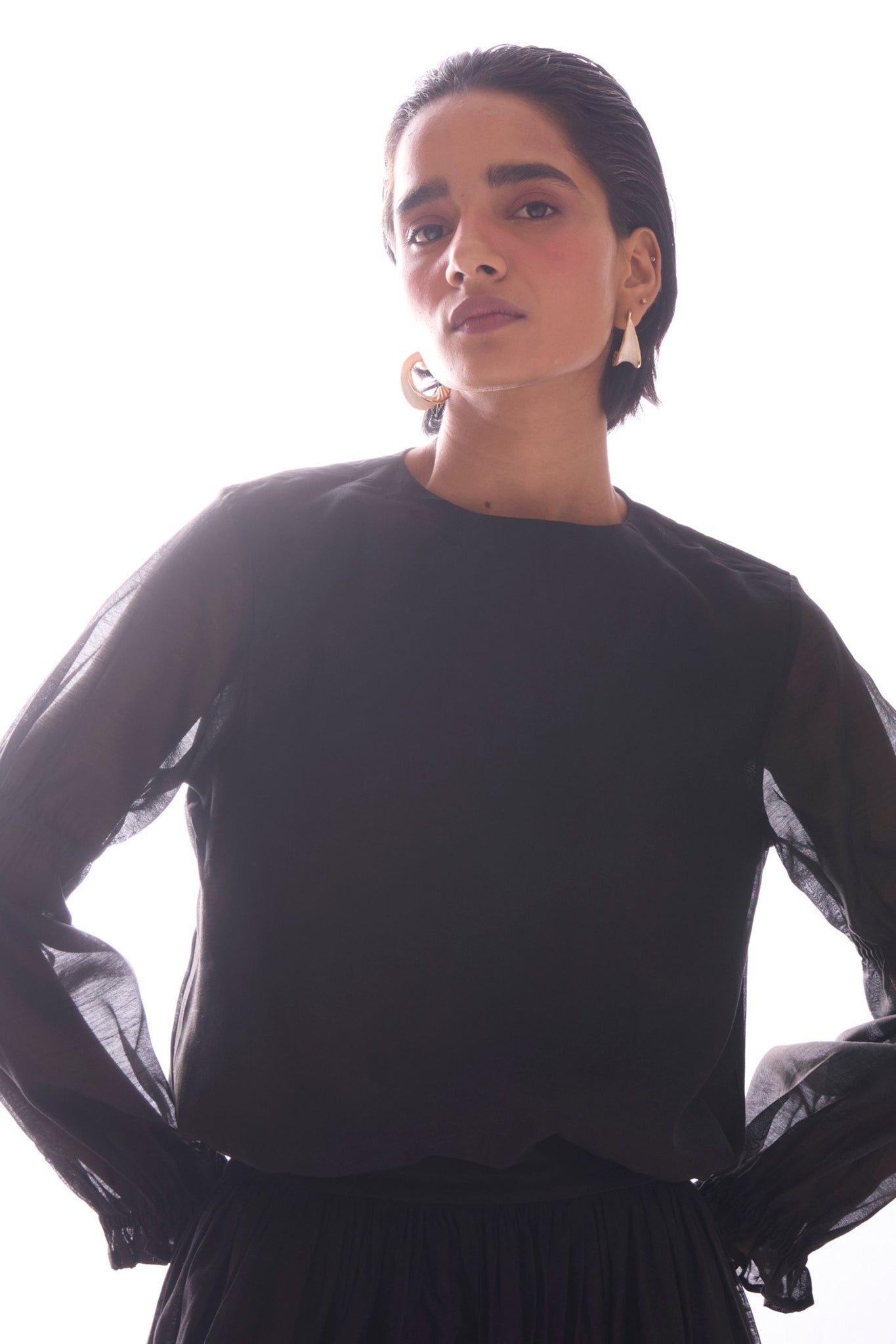 Black handwoven Chanderi top with drawstring waist, back button fastening, and elasticated sleeve details.