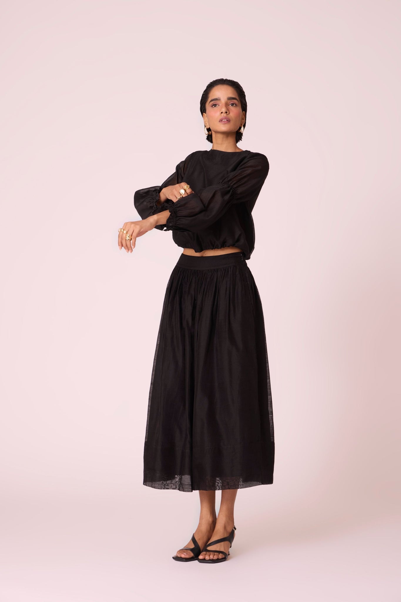 Black handwoven Chanderi top with drawstring waist, back button fastening, and elasticated sleeve details.