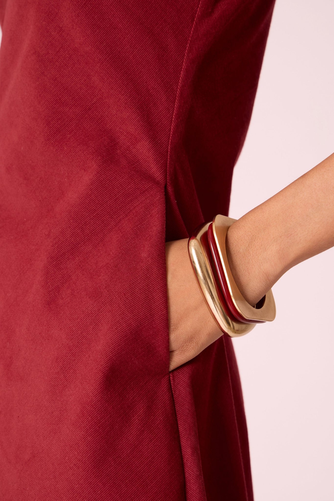 Rust needlecord midi dress with fitted bodice, back slit, back zip fastening, and in-seam pockets.