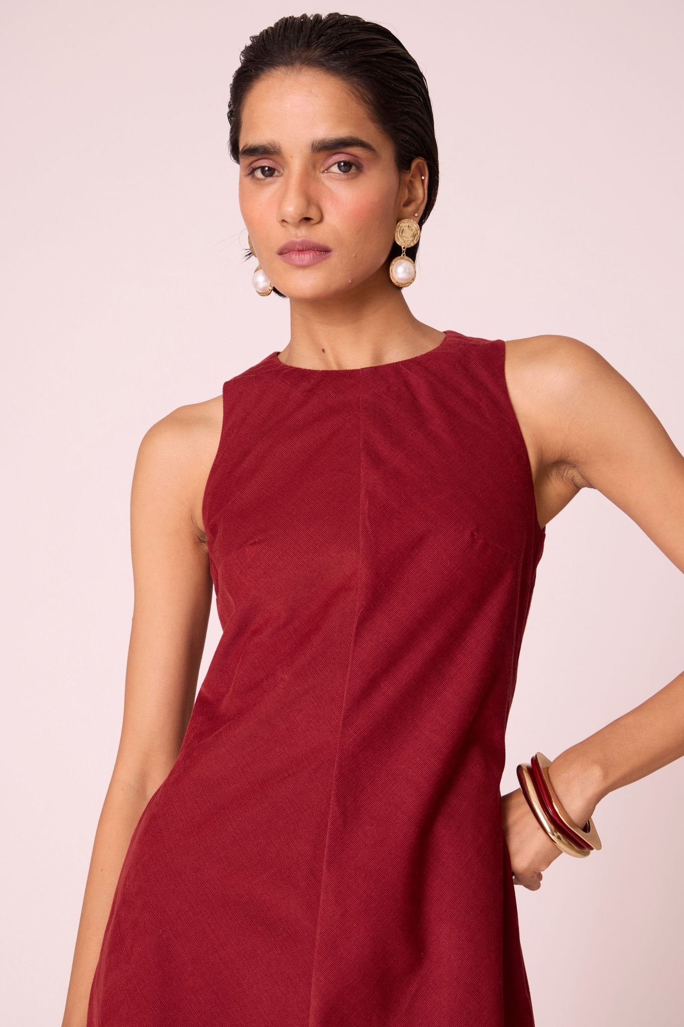 Rust needlecord midi dress with fitted bodice, back slit, back zip fastening, and in-seam pockets.