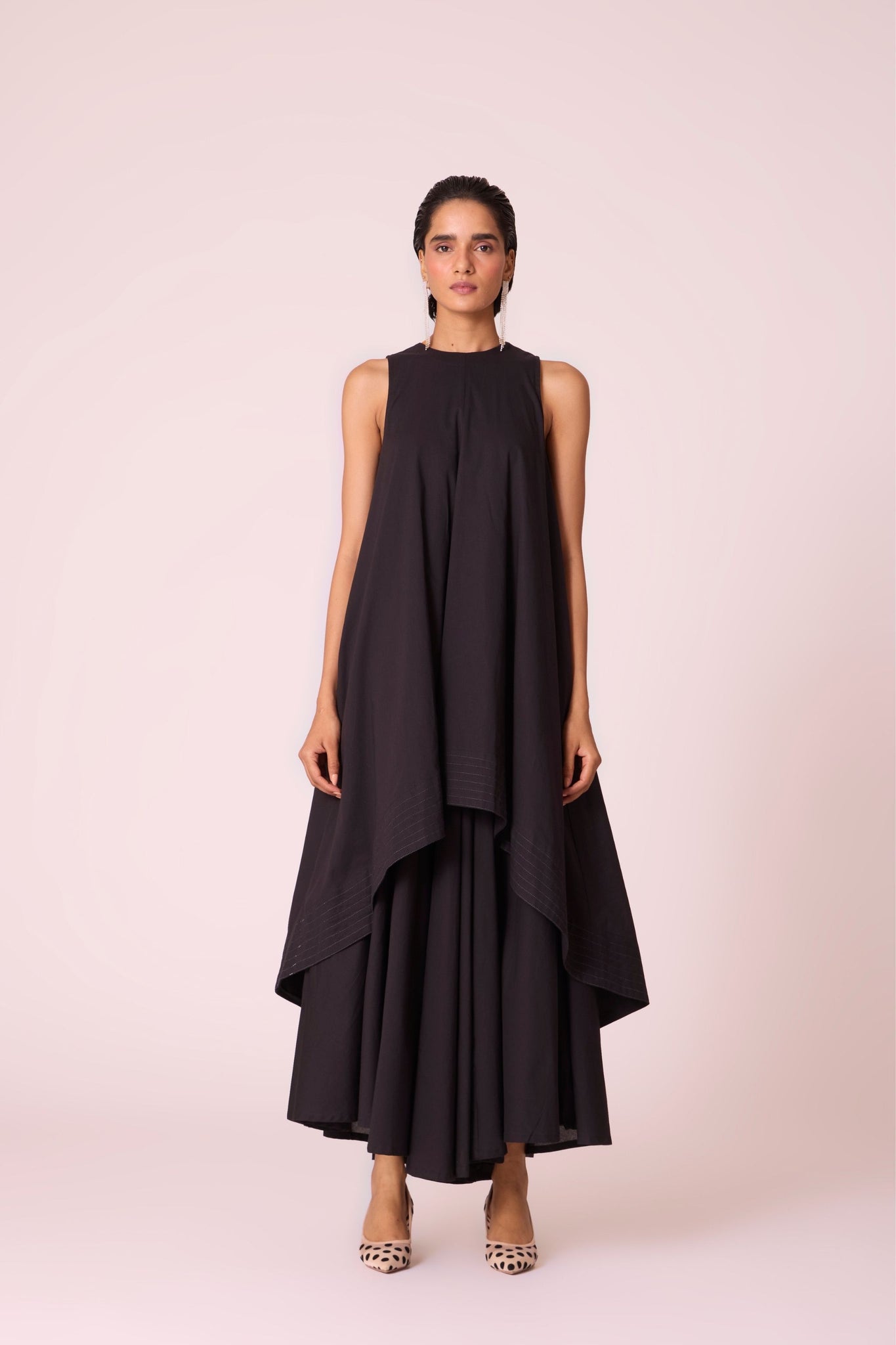 Black layered maxi dress in organic cotton cambric with in-cut shoulders and rouleau back fastening.
