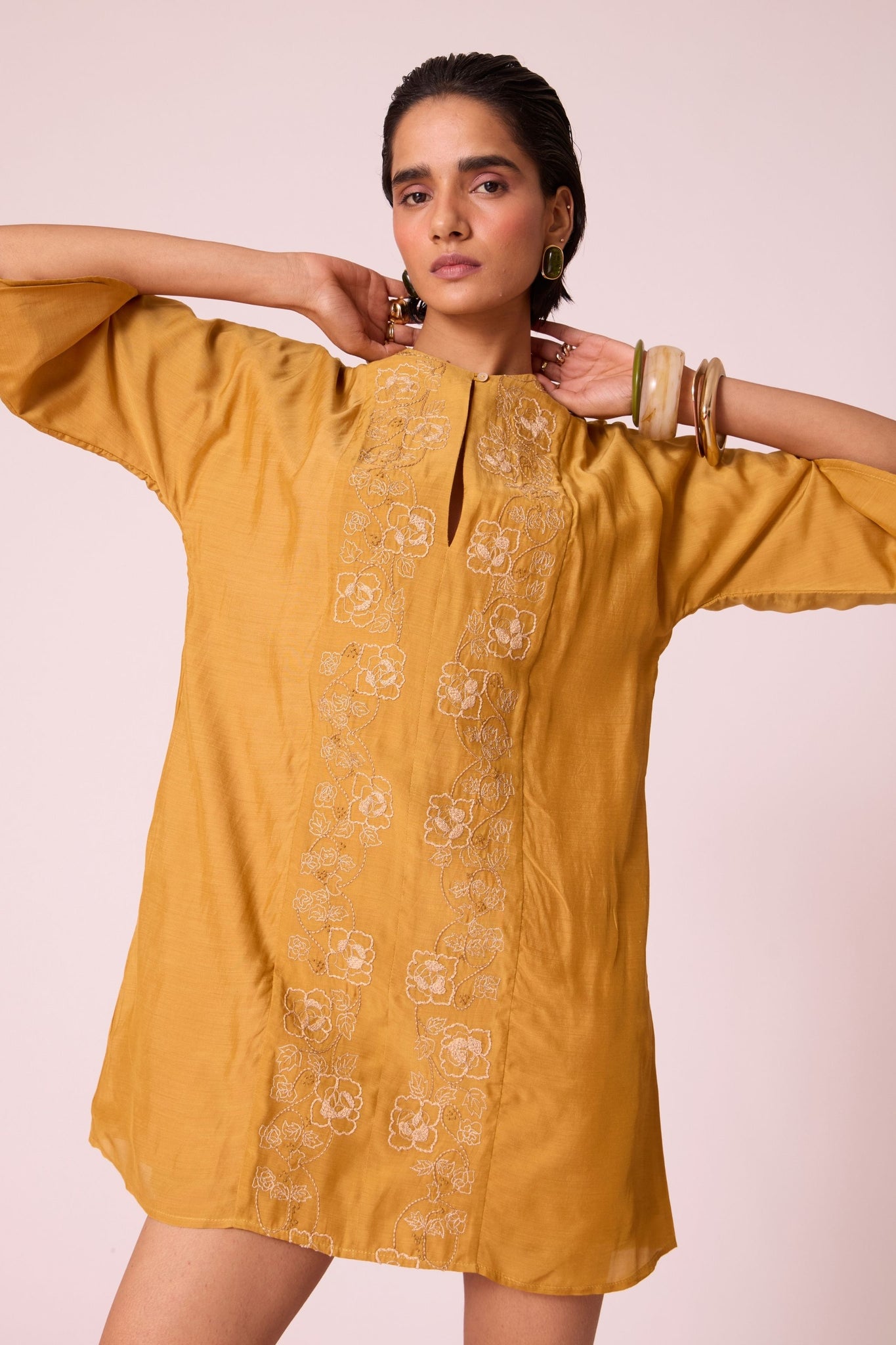 Yellow cupro dress with hand-embroidered keyhole neckline, drop sleeves, full lining, and in-seam pockets.
