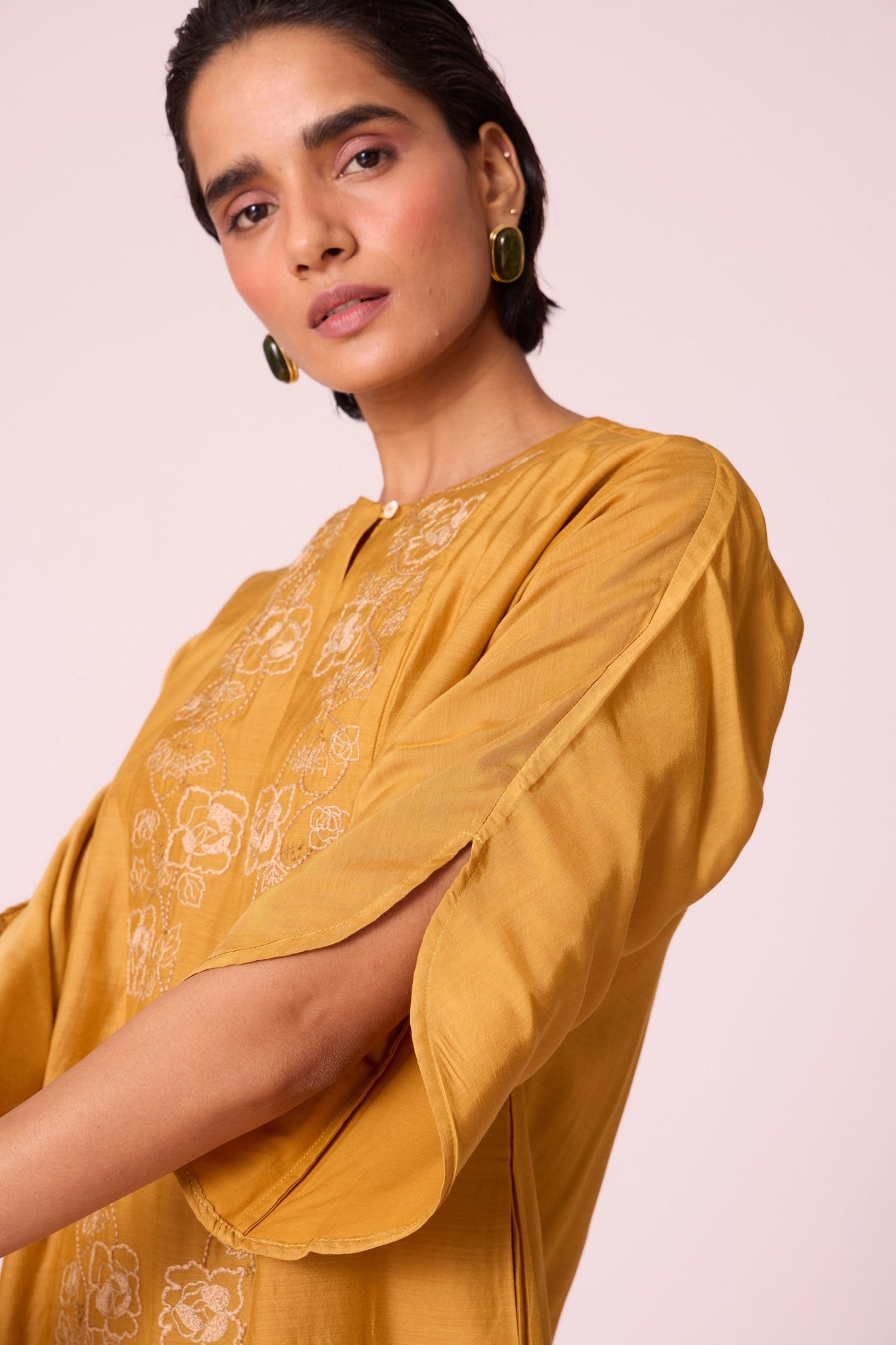 Yellow cupro dress with hand-embroidered keyhole neckline, drop sleeves, full lining, and in-seam pockets.
